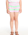 Girl wearing the Chaser Kids Pinky Aloe Stripe Jade Short featuring wide pastel pink and aloe green stripes and a comfy elastic waistband