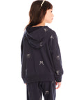 Back view of girl wearing Chaser’s navy blue Tossed Glitter Bows Zip Up Hoodie with embroidered bows on a white background
