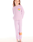 Full body view of girl wearing Chaser’s pink Rainbow Glitter Pants with rainbow heart design and matching pullover on a white background
