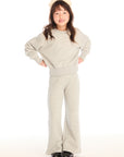 Full body view of girl wearing Chaser’s Danni Heather Grey Pullover with matching Tara Leggings on a white background