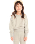 Girl wearing Chaser’s Danni Heather Grey Pullover with matching Tara Leggings on a white background