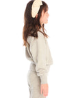Side view of girl wearing Chaser’s Danni Heather Grey Pullover with matching Tara Leggings on a white background