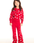 Full body view of girl wearing Chaser’s Danni Rouge Pullover with star patterns and matching Tara Leggings on a white background