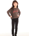Full body view of girl wearing Chaser’s Blondie Leopard & Hearts print pullover top with red text and black pants on a white background