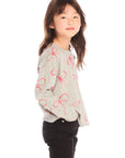 Side view of girl wearing Chaser’s gray Red Bows Long Sleeve with pink bow pattern on a white background