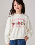 Model wearing Chaser's Grateful Dead 'Tis the Season Girls Pullover in whisper white with Grateful Dead graphic, front view