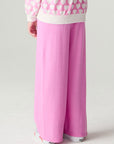 Back view of a girl wearing the Chaser Love Is Everywhere Girls Pants Jogger with matching pink pants