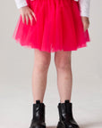 Model wearing Chaser's Holiday Ombre Girls Tulle Skort in hot bubble gum with distinctive graphic and design details, front view