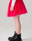 Model wearing Chaser's Holiday Ombre Girls Tulle Skort in hot bubble gum with distinctive graphic and design details, side view