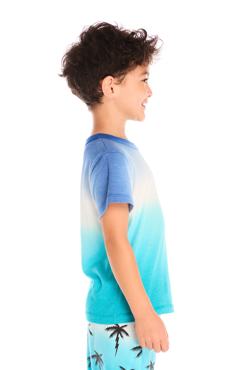 Side view of boy wearing Chaser Kids Lightning Palm Tee showing ombré fade and short sleeves, white background