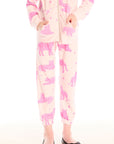 Girl wearing Chaser’s Celestial Tigers Sweatpant with pink animal pattern on a white background