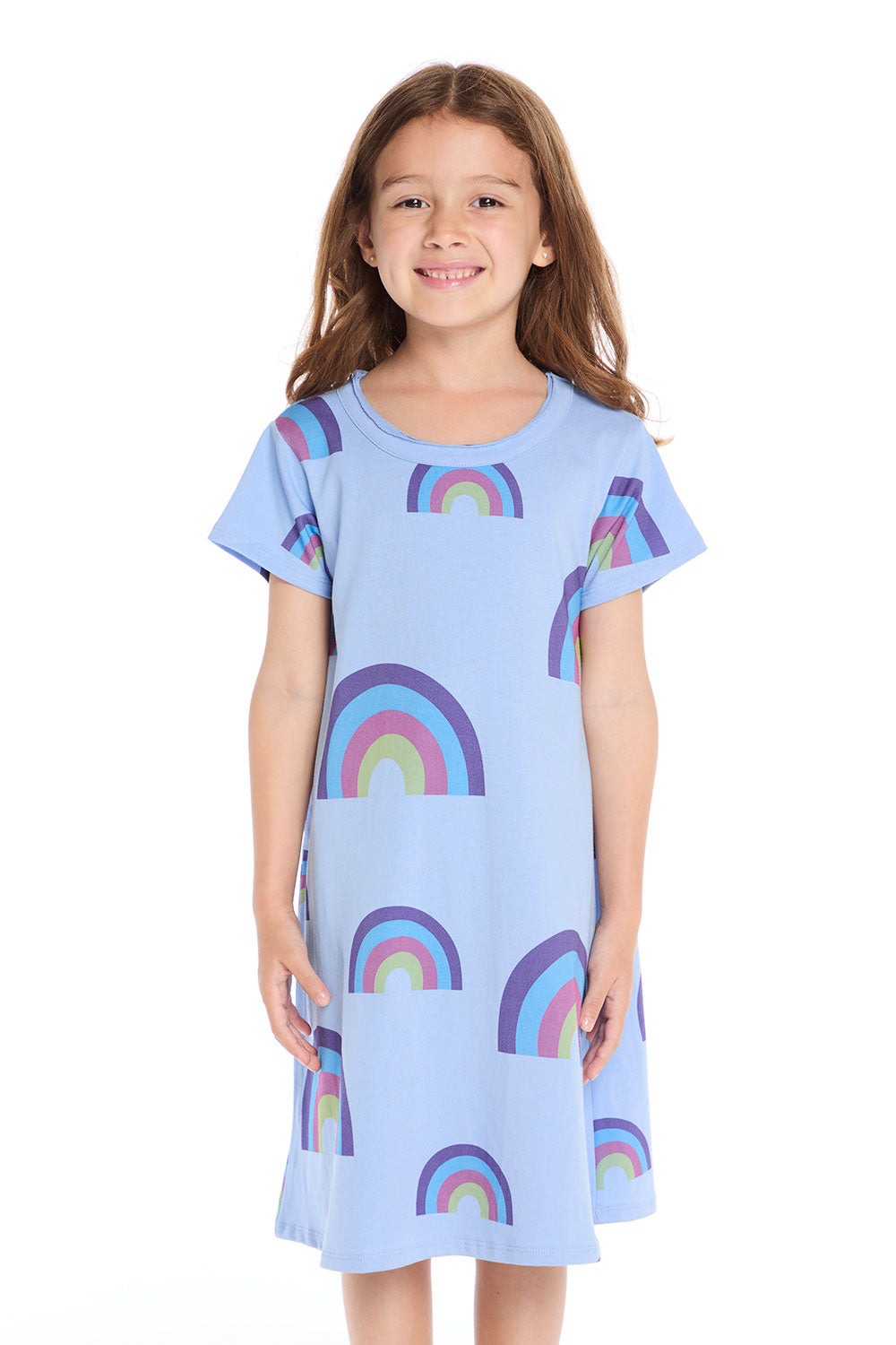 Girl wearing the Chaser Kids Allover Rainbows Short Sleeve Shirt Dress in Blue Hydrangea with colorful rainbow graphics on a white background