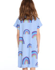 Back view of the Chaser Kids Allover Rainbows Short Sleeve Shirt Dress in Blue Hydrangea with allover rainbow prints on a white background