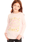 Girl wearing Chaser’s light pink The Beatles Strawberry Fields Forever Long Sleeve with floral design on a white background