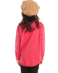 Back view of girl wearing Chaser’s red Hot Chocolate Weather Long Sleeve with black pants on a white background