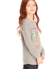 Side view of girl wearing Chaser’s gray The Rolling Stones Spiral Tongues Long Sleeve with colorful logo designs and text on a white background