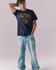 Full body view of model wearing navy Halftime 1984 tee.