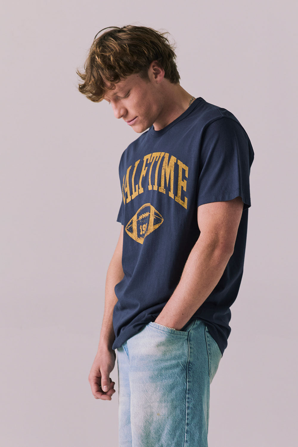 Side view of retro Halftime 1984 tee in navy.