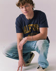 Full body view of model wearing navy Halftime 1984 tee.