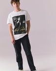 Full body of model in white Elvis tee with Sun Records design.