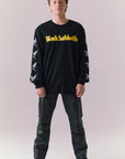 Full body view of model wearing Black Sabbath true black graphic long sleeve tee.