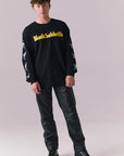 Full body view of model wearing Black Sabbath washed black graphic long sleeve tee.