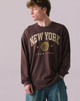 Front view of New York 1975 long sleeve tee in Kahlua Brown with cityscape graphic.