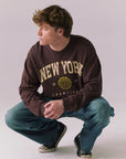 Full body of model in Kahlua Brown New York 1975 long sleeve tee.