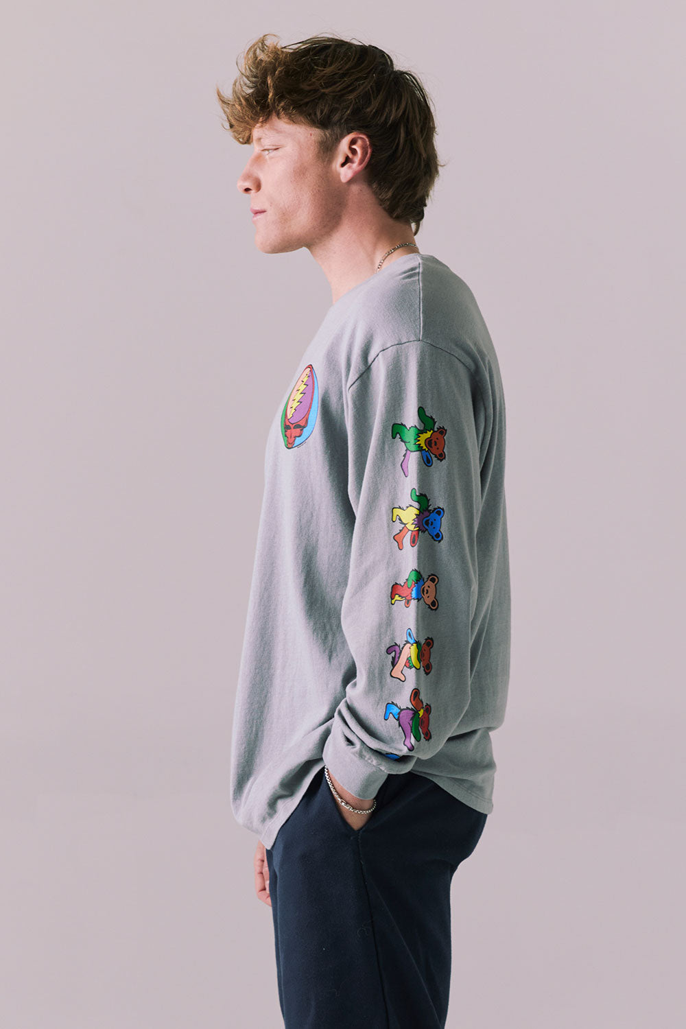 Side view of silver grey graphic long sleeve featuring vibrant skull sleeve detail.