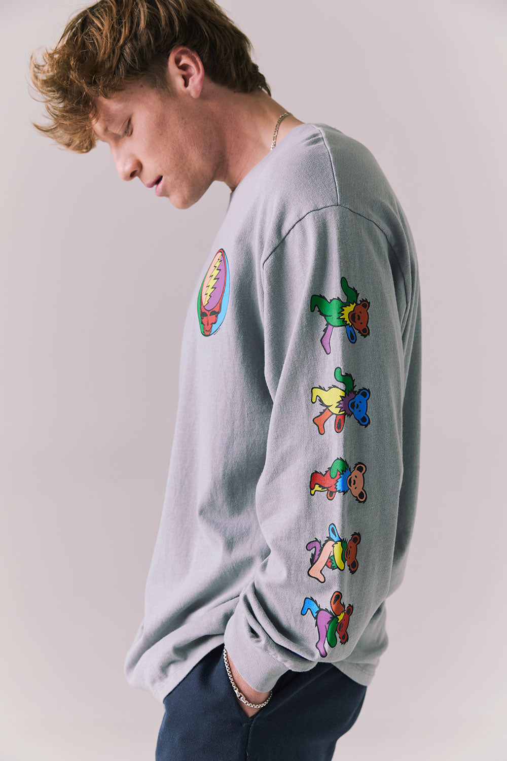 Side view of silver grey graphic long sleeve featuring vibrant skull sleeve detail.