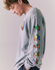 Side view of silver grey graphic long sleeve featuring vibrant skull sleeve detail.