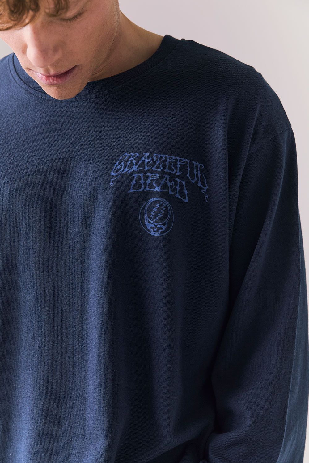 Front view of long sleeve tee in Dark and Stormy Blue with subtle Stealie skull design.