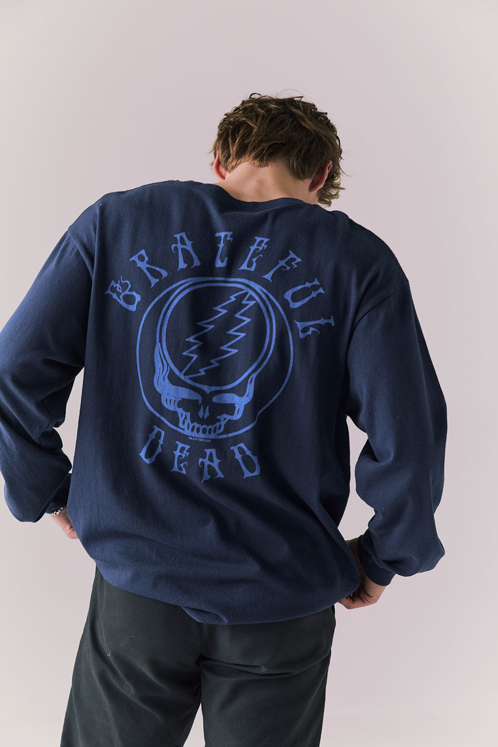 Back of Deadhead long sleeve with understated Stealie skull line art.