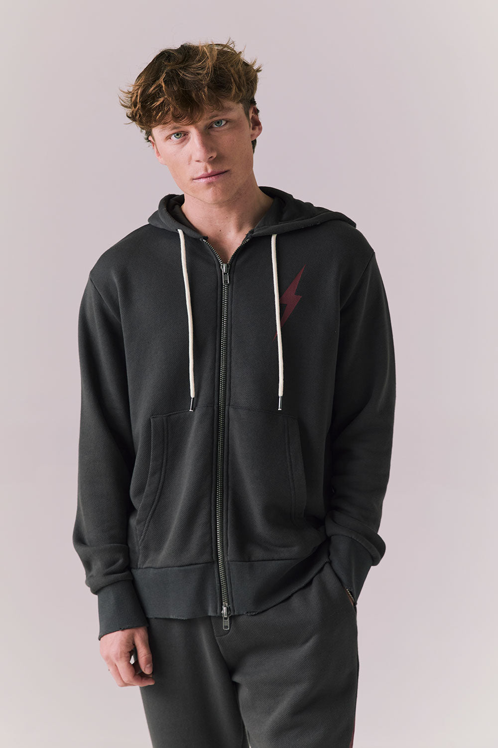 Front view of Bolt Black Hoodie with tonal lightning bolt design.