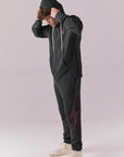 Side full body of model in Bolt Black Hoodie and pants set.