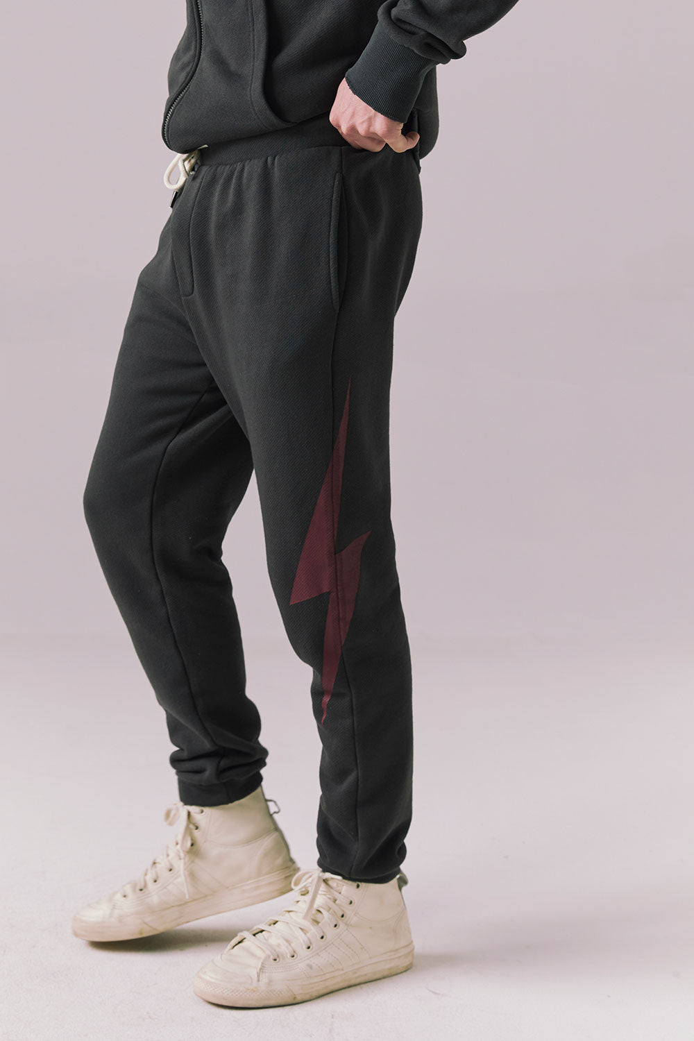 Side view of tapered Bolt Black Pants with drawstring waist.