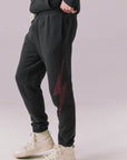 Side view of tapered Bolt Black Pants with drawstring waist.