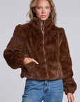 Model wearing Chaser's Dark Chocolate Puff Sleeve Jacket in deep brown plush faux-fur texture with oversized puff sleeves, front view