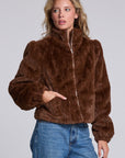 Model wearing Chaser's Dark Chocolate Puff Sleeve Jacket in deep brown plush faux-fur texture with oversized puff sleeves, angled view