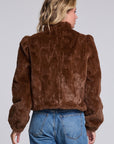 Model wearing Chaser's Dark Chocolate Puff Sleeve Jacket in deep brown plush faux-fur texture with oversized puff sleeves, back view