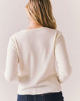 Back view of model wearing Aspen 1979 Long Sleeve in white