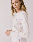 Side view of woman wearing Chaser's Allover Skiers with small colorful patterns on a light gray background