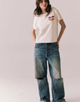 Full front view of Lake Tahoe Ombre Tee in starry white with soft gradient fade, heart-shaped graphic design, relaxed silhouette and blue jeans on a plain background