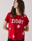 Front view of woman wearing Chaser’s Rouge Red David Bowie Ziggy Stardust Tee with white star designs on a light gray background (Licensed band collaboration — features official David Bowie branding for SEO relevance)
