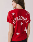 Back view of woman wearing Chaser’s Rouge Red David Bowie Ziggy Stardust Tee with 'STARDUST' printed on the back against a plain background (Licensed band collaboration — features official David Bowie branding for SEO relevance)