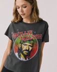 Front view of woman wearing Chaser’s Willie Nelson Willie Christmas Tee with colorful holiday graphic design on a plain background (licensed band collaboration)