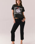 Full body look of model wearing cropped Stones Dice Tour tee with jeans.