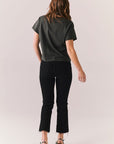 Back full body of model styled in cropped black band tee.