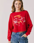 Woman wearing Chaser's red Apres Ski Cheers with graphic design on a plain background