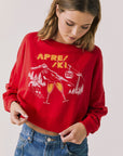 Woman wearing Chaser's red Apres Ski Cheers with graphic design on a plain background